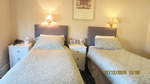 A twin bedroom at Hunters Lodge Hotel
